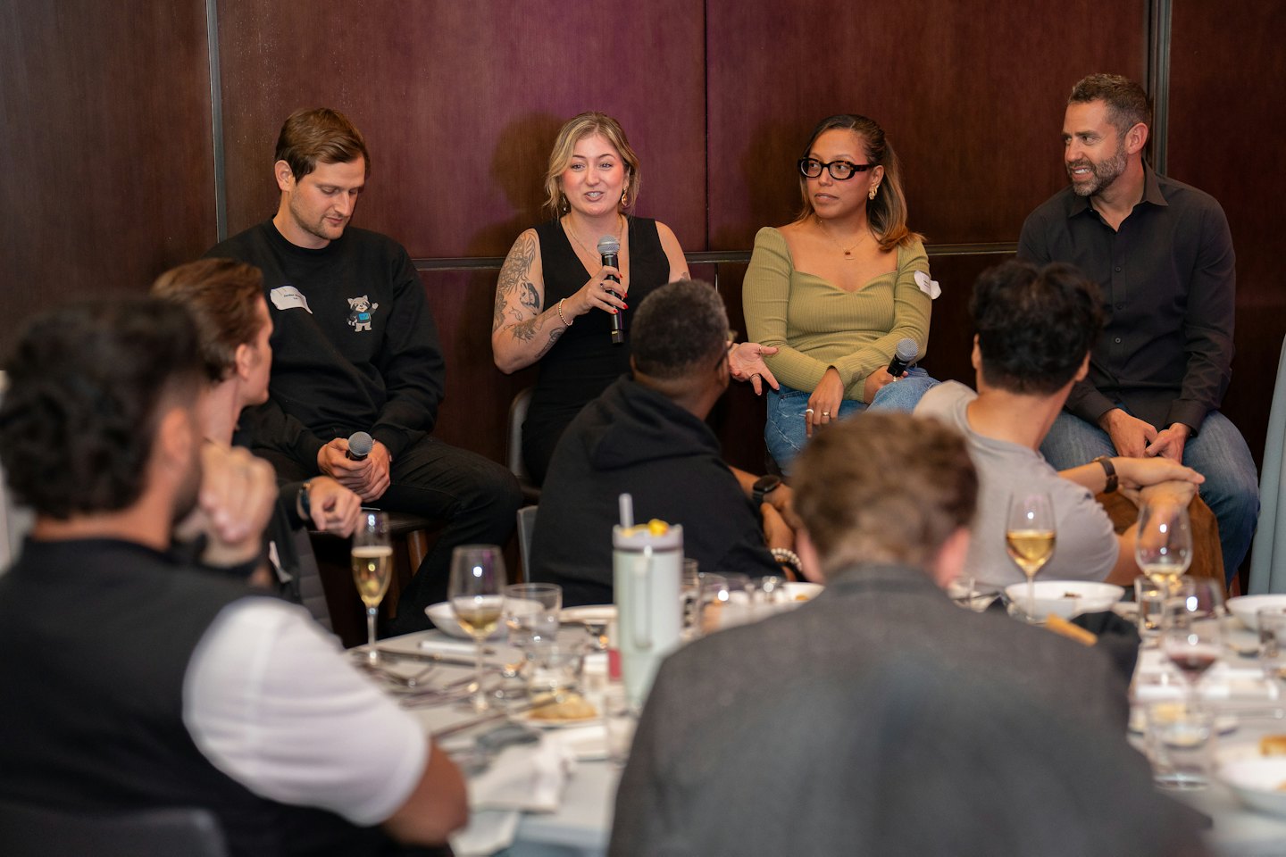 A panel discussion with a woman speaking into a microphone.